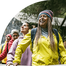 Women smiling and hiking for exercise
